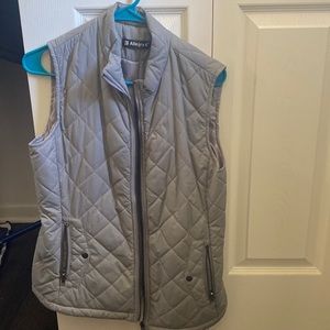Women’s vest, waterproofed material. Two pockets, grey color.